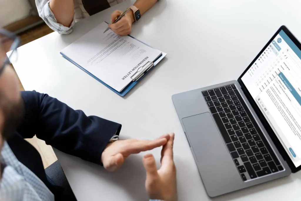 Two people navigating internet for legal document translation services