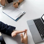 Two people navigating internet for legal document translation services